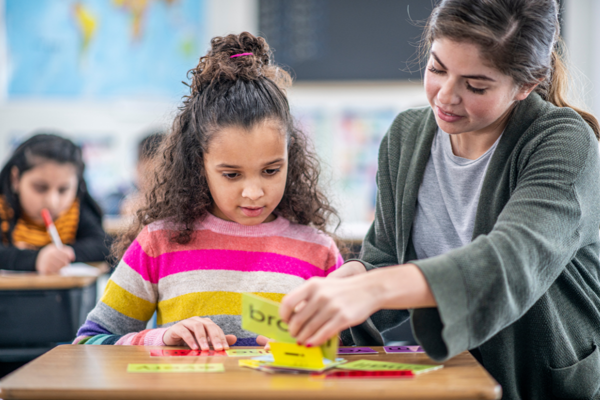 student working with her teacher